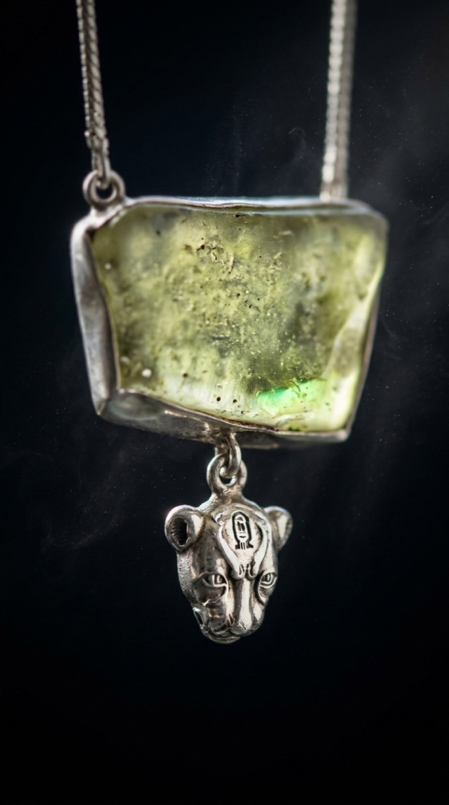 The lioness Sekhmet in silver beneath the stone